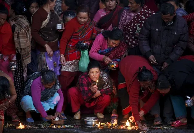 Devotees offer prayers along the bank of Hanumante River during the final day of the month-long Swasthani Brata Katha festival in Bhaktapur, Nepal, February 22, 2016. (Photo by Navesh Chitrakar/Reuters)