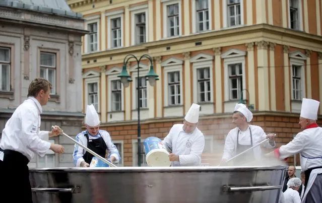 Bosnian chefs cook in a Guinness Book of World Records attempt for the largest chicken broth, in a central square of the Bosnian capital of Sarajevo, April 17, 2015. (Photo by Dado Ruvic/Reuters)