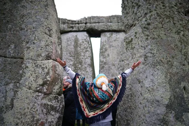 A person gestures during winter solstice celebrations at Stonehenge near Amesbury, Britain on December 22, 2022. (Photo by Henry Nicholls/Reuters)
