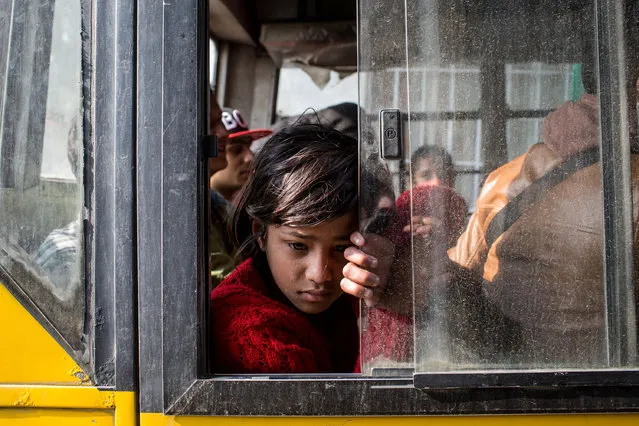 A young girl waits on board a bus to be evacuated from the city center on April 29, 2015 in Kathmandu, Nepal. (Photo by Chris McGrath/Getty Images)