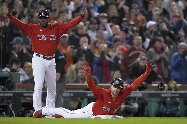 Boston Red Sox's Christian Arroyo celebrates a triple against the Houston Astros during the fourth inning in Game 4 of baseball's American League Championship Series Tuesday, October 19, 2021, in Boston. (Photo by David J. Phillip/AP Photo)
