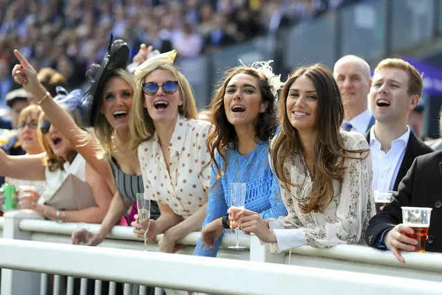 Racegoers at the rails during the premier horse racing day at The Grand National Festival, at Aintree Racecourse in Liverpool, England, Saturday April 6, 2019. 40 horses will compete in the challenging Grand National event later Saturday, with its notoriously high fences spread over a four mile course, attracting large crowds of racegoers and an international TV audience. (Photo by Nigel French/PA Wire Press Association via AP Photo)