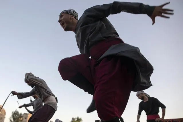 Palestinians wear a traditional uniform perform during a folklore dancing festival in Gaza City, Thursday, October 7, 2021. (Photo by Khalil Hamra/AP Photo)