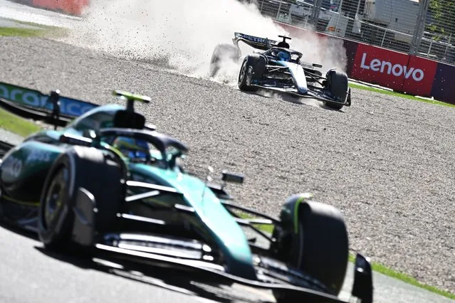 Mercedes' British driver George Russell goes off the track behind Aston Martin's Spanish driver Fernando Alonso during the Australian Formula One Grand Prix at Albert Park Circuit in Melbourne on March 24, 2024. (Photo by Paul Crock/AFP Photo)