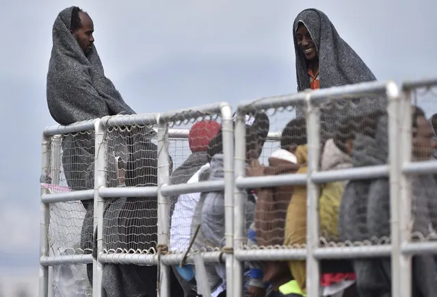 Migrants wait to disembark from the Migrant Offshore Aid Station (MOAS) vessel “Phoenix” in the harbor of Messina, Sicily, Southern Italy, Saturday, May 15, 2015. (Photo by Carmelo Imbesi/AP Photo)