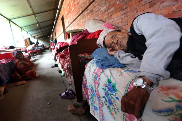 A Nepalese elderly man sleeping in makeshift shelter at the social welfare centre Briddhashram (old age home) in Pashputi, Kathmandu, Nepal 19 May 2015. Many elderly residents are living in makeshift accomodation following the damed to old peoples homes. (Photo by Harish Tyagi/EPA)