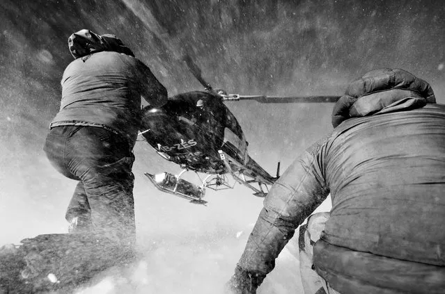 “A Guides Eye View”. Two mountain guides direct a helicopter into land high in the Swiss Alps on top of Mt. Gond. I took this shot whilst shooting an extreme ski and snowboard competition – the Nendaz Freeride FWQ. I had been dropped just before on the peak and with the permission of the guides cowered down behind them to capture this shot when the remaining supplies were delivered. Photo location: Mt. Gond, Haute-Nendaz, Switzerland. (Photo and caption by Philip Field/National Geographic Photo Contest)