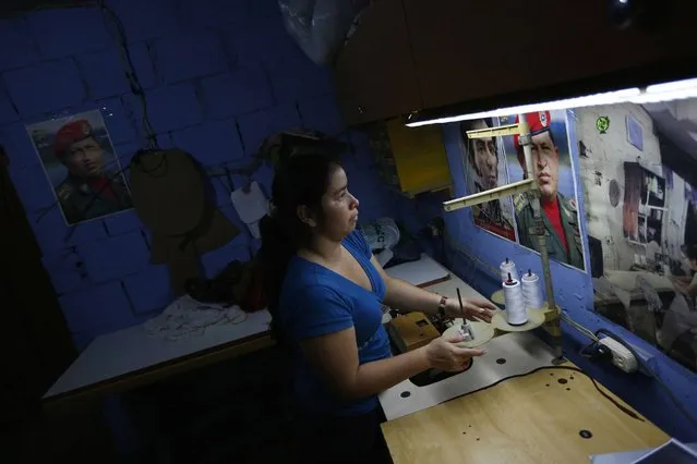 Maria works in a sewing workshop in her apartment inside the “Tower of David” skyscraper in Caracas. (Photo by Jorge Silva/Reuters)