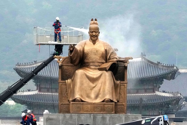 A worker sprays water onto the statue of King Sejong for a spring cleaning at the Gwanghwamun Plaza in Seoul, South Korea, Tuesday, April 16, 2024. King Sejong, the fourth king of the Joseon Dynasty (1392-1910), created the Korean alphabet, Hangul, in 1446. (Photo by Ahn Young-joon/AP Photo)