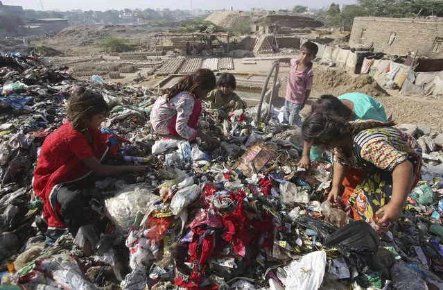 Pakistan children sort through garbage for recycleable items to sell, at a dump in Karachi, Pakistan, Thursday, April 4, 2019. (Photo by Fareed Khan/AP Photo)