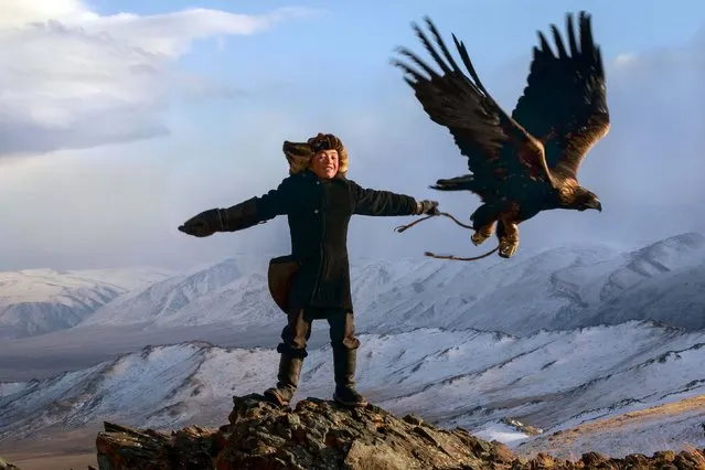 13 year old Irka Bolen with his eagle. Tradition wise, when a boy turns 13, then are strong enough to hold the weight of a fully grown eagle. (Photo by Asher Svidensky/Caters News)