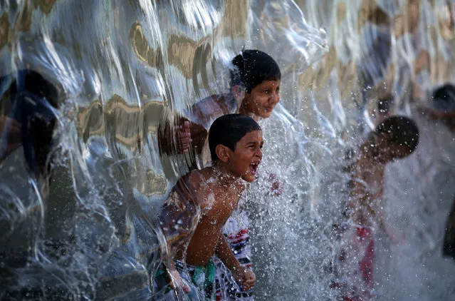 Children play with water in Madureira Park in Rio de Janeiro, Brazil February 12, 2017. (Photo by Pilar Olivares/Reuters)