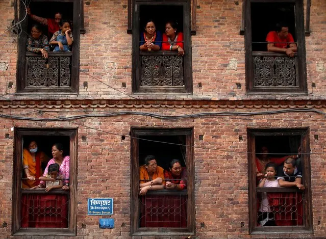 People observe the Nil Barahi mask dance festival, an annual event during which dancers perform while posing as various deities that people worship to seek blessings, in Bode, Nepal on August 20, 2019. (Photo by Navesh Chitrakar/Reuters)