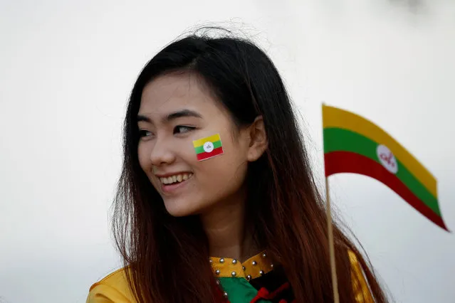 Ethnic Shan woman, wearing the colours of the Shan National flag on her face, attends the Shan State Army-South march in formation during a military parade celebrating the 69th Shan State National Day at Loi Tai Leng, the group's headquarters, on the Thai-Myanmar border February 7, 2016. (Photo by Soe Zeya Tun/Reuters)