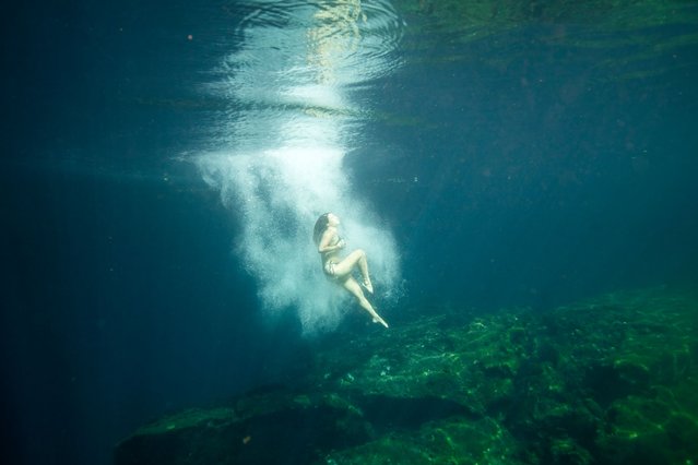 A tourist dives into the “Jardin del Eden”, or Eden's Garden cenote, near Tulum, Mexico, Wednesday, February. 28, 2024. These glowing sinkhole lakes, known as cenotes, are a part of one of Mexico's natural wonders: A fragile system of thousands of subterranean caverns, rivers, and lakes that wind beneath Mexico's southern Yucatan peninsula.(AP Photo/Rodrigo Abd)