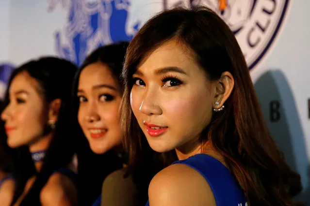 Leicester City hostesses pose for a picture in front of a billboard as people gather to watch the team's English Premier League soccer match against Everton on a big screen, in Bangkok, Thailand, May 7, 2016. (Photo by Jorge Silva/Reuters)