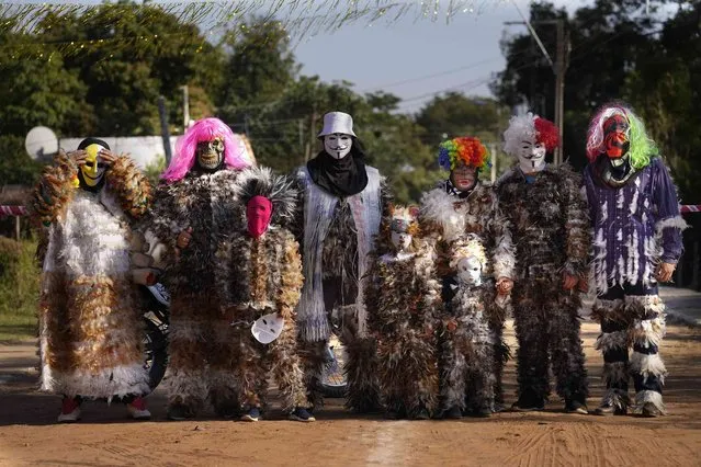 Catholic parishioners pose for a group portrait wearing their feathered costumes during the feast of St. Francis Solano, in Emboscada, Paraguay, Saturday, July 24, 2021. Legend has it that while lying on his death bed in a Peruvian convent, birds perched on Solano's window and would sing to him, inspiring his followers to dress in bird costumes. (Photo by Jorge Saenz/AP Photo)