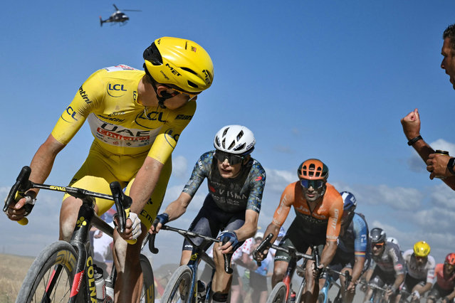 UAE Team Emirates team's Slovenian rider Tadej Pogacar wearing the overall leader's yellow jersey looks back as he cycles ahead of Team Visma - Lease a Bike team's Danish rider Jonas Vingegaard (2nd L) over a “Chemin Blanc” (white road) gravel sector during the 9th stage of the 111th edition of the Tour de France cycling race, 199km stage departing and finishing in Troyes, on July 7, 2024. (Photo by Marco Bertorello/AFP Photo)