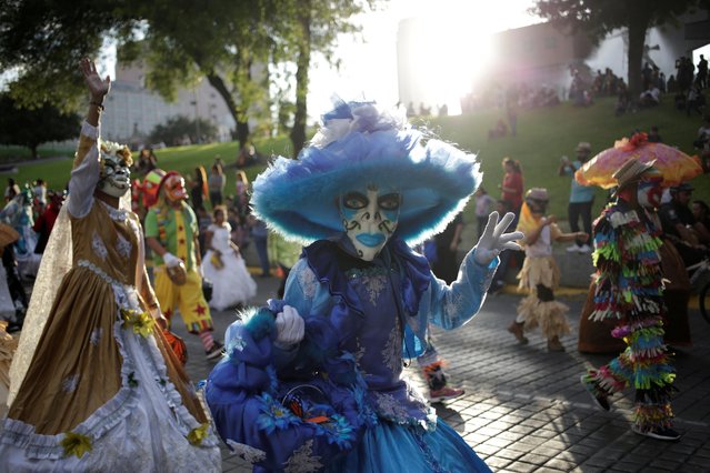 People take part in a Catrina parade ahead of Day of the Dead in Monterrey, Mexico on October 27, 2019. (Photo by Daniel Becerril/Reuters)