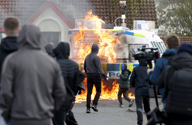 Youths throw petrol bombs at a PSNI vehicle ahead of a dissident Republican parade in the Creggan area of Londonderry on Easter Monday on Monday, April 10, 2023. Authorities have increased security measures in response to the unnotified parades being held in Derry. (Photo by Liam McBurney/PA Wire Press Association)