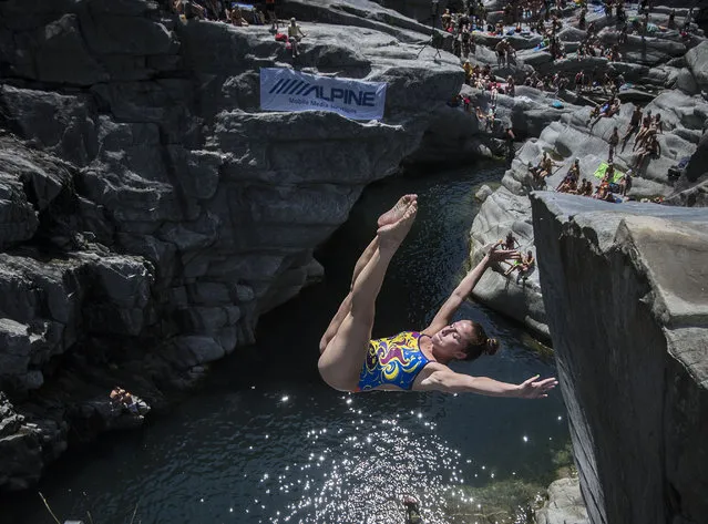 Jaqueline Valente from Brazil jumps from a cliff during a cliff diving competition in the Maggia valley in Ponte Brolla, southern Switzerland, Saturday, July 25, 2015. (Photo by Samuel Golay/Keystone/Ti-Press via AP Photo)