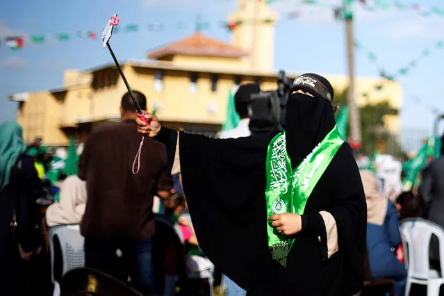 A Palestinian Hamas supporter takes a selfie during an anti-Israeli rally in Gaza city April 28, 2016. (Photo by Suhaib Salem/Reuters)