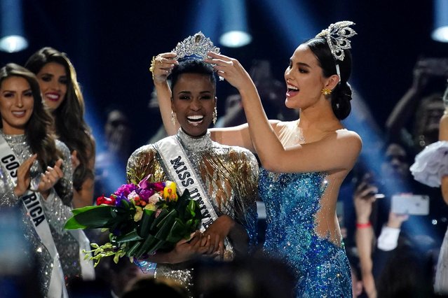 Zozibini Tunzi, of South Africa, is crowned Miss Universe by her predecessor, Catriona Gray of the Philippines, at the 2019 Miss Universe pageant at Tyler Perry Studios in Atlanta, Georgia, U.S. December 8, 2019. (Photo by Elijah Nouvelage/Reuters)