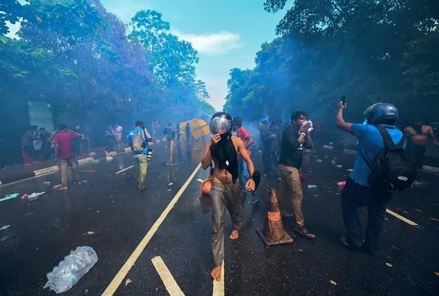 Police use tear gas to disperse University students protesting to demand the resignation of Sri Lanka's President Gotabaya Rajapaksa over the country's crippling economic crisis, near the parliament building in Colombo on May 6, 2022. (Photo by Ishara S. Kodikara/AFP Photo)