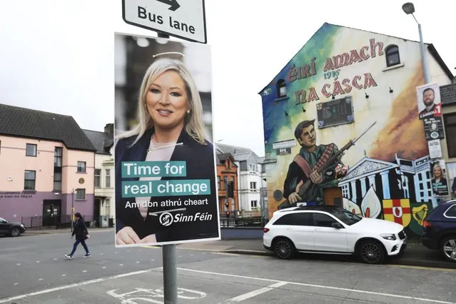 A Sinn Fein election poster hangs from a lamp post in West Belfast, Northern Ireland, Tuesday, May 3, 2022. (Photo by Peter Morrison/AP Photo)