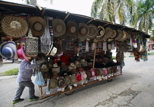 A seller pushes his home made cart with traditional hats during the 12th La Joropera festival in Acacias near Villavicencio in this October 14, 2012 file photo. Colombia is expected to release inflation numbers this week. (Photo by John Vizcaino/Reuters)