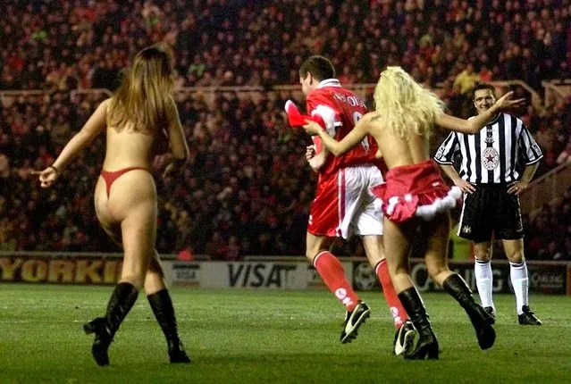 Middlesbrough star Paul Gasgoigne is confronted by streakers at The Riverside on December 6, 1998 during their match against Newcastle. (Photo by Owen Humphreys – PA Images/PA Images via Getty Images)