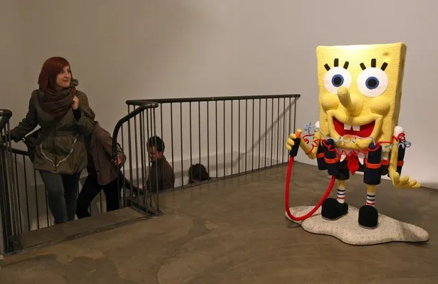 The knitted sculpture 'Spongebob' by Patricia Waller, featuring the cartoon character as a suicide bomber, stands in the 'Broken Heroes' exhibition at the Deschler Gallery