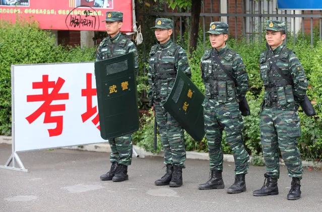 Paramilitary policemen guard at an examination place during China's annual National College Entrance Exam in Shaotong, Yunnan Province, China, June 7, 2016. (Photo by Reuters/China Daily)