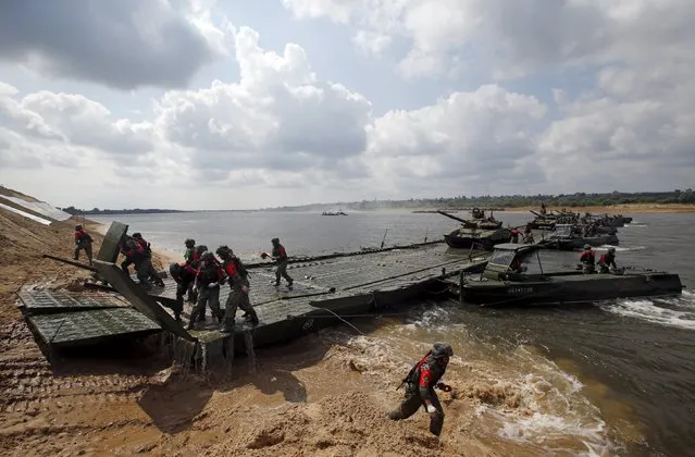 Members of the Chinese team transport tanks on a pontoon bridge during the Open Water competition for pontoon bridge units as part of the International Army Games-2015 in the town of Murom, Russia, August 8, 2015. (Photo by Maxim Zmeyev/Reuters)