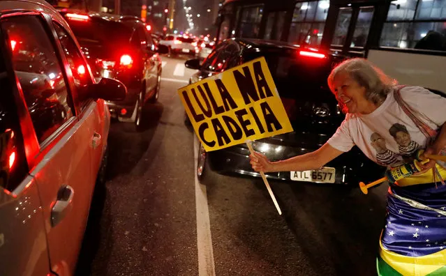 A woman celebrates after former Brazilian President Luiz Inacio Lula da Silva, was convicted on corruption charges and sentenced to nearly 10 years in prison in Sao Paulo, Brazil July 12, 2017. The sign reads: “Lula in Jail”. (Photo by Nacho Doce/Reuters)