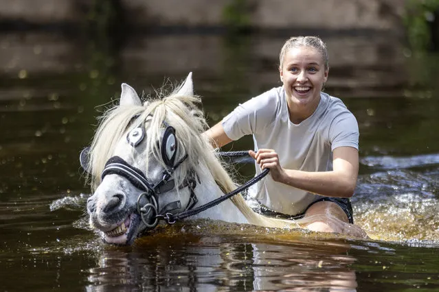 A woman rides her horse in the river on the first day of the Appleby Horse Fair on June 9, 2022. Appleby Horse Fair is an annual gathering of Travellers & Gypsies in the town of Appleby in Cumbria & attracts roughly 10,0000 Travellers & about 30,000 visitors over the three day period it is held. (Photo by Andrew McCaren/London News Pictures)