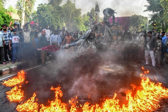 A Hindu devotee performs around the fire during a religious procession in Chandigarh on October 5, 2024. (Photo by AFP Photo/Stringer)