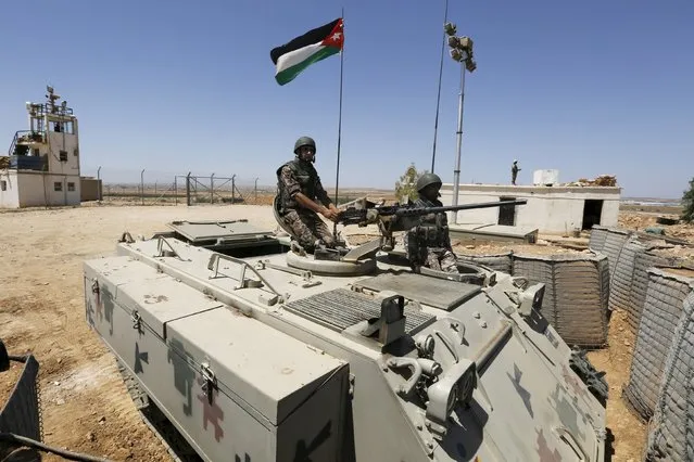 Soldiers stand guard on a tank at the Jordanian-Syrian border, near Mafraq, Jordan August 16, 2015. Commander of the Jordanian Border Guard, Brigadier General Saber Mahayrah, said on Sunday that there was no sign of Nusra Front or Islamist State fighters on the border between Jordan and Syria. (Photo by Muhammad Hamed/Reuters)