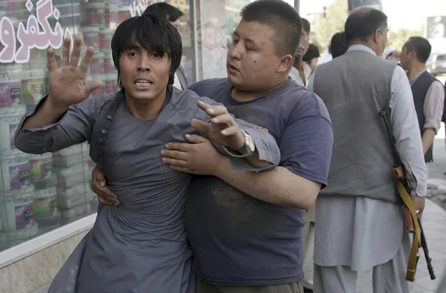 A shocked man shouts slogans against the Afghan President after he ran out of the Shiite mosque during an ongoing attack, Kabul, Afghanistan, Friday, August 25, 2017. Gunmen stormed a Shiite mosque in the Afghan capital while worshippers were at Friday prayers, setting off an explosion that killed a security guard outside and pushing into the shrine, officials said. (Photo by Massoud Hossaini/AP Photo)