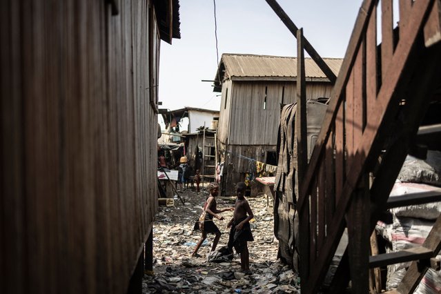 Children play in the Ago Egun community slum in Bariga neighbourhood in Lagos, on November 30, 2024. (Photo by Olympia de Maismont/AFP Photo)