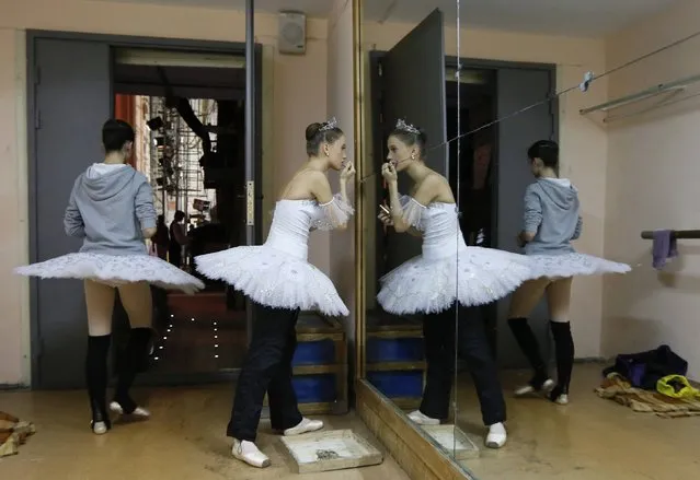 Contestants prepare backstage before their performance during the “Grand Prix of Siberia” international ballet competition, held as part of the 3rd International Forum “Ballet of the XXI Century”, at the State Opera and Ballet Theatre in Krasnoyarsk October 8, 2014. About 50 ballet dancers from nine countries including Japan, Italy, Germany, Turkey and Bulgaria took part in the competition judged by a jury headed by the well-known Russian choreographer Yuri Grigorovich, as part of the 5-day-long forum, according to local media and official representatives of the theatre. (Photo by Ilya Naymushin/Reuters)