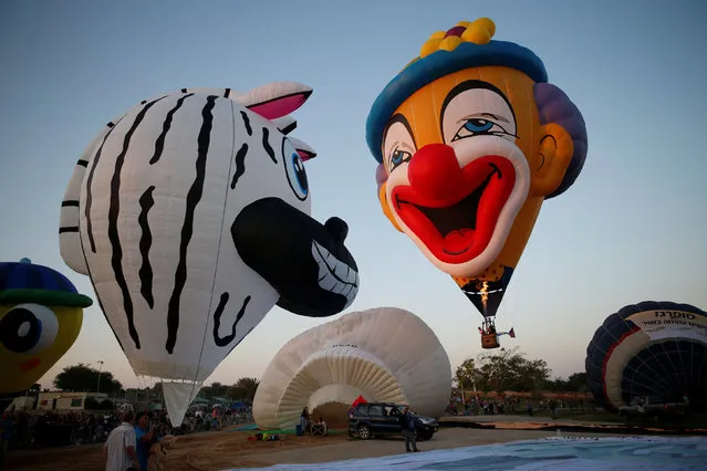 Hot air balloons are prepared before they take flight during a two-day international hot air balloon festival in Eshkol Park near the southern city of Netivot, Israel July 22, 2016. (Photo by Amir Cohen/Reuters)