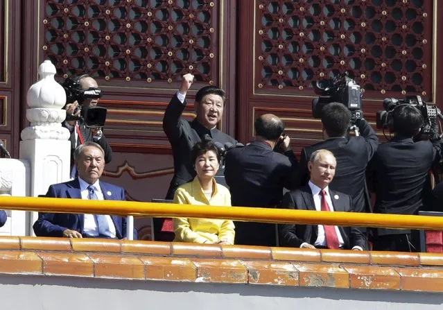 China's President Xi Jinping (C, behind) gestures as he delivers a speech behind Russia’s President Vladimir Putin (R), South Korea’s President Park Geun-hye (C) and Kazakhstan's President Nursultan Nazarbayev on Tiananmen Gate during a military parade to mark the 70th anniversary of the end of World War Two, in Beijing, China, September 3, 2015. (Photo by Jason Lee/Reuters)