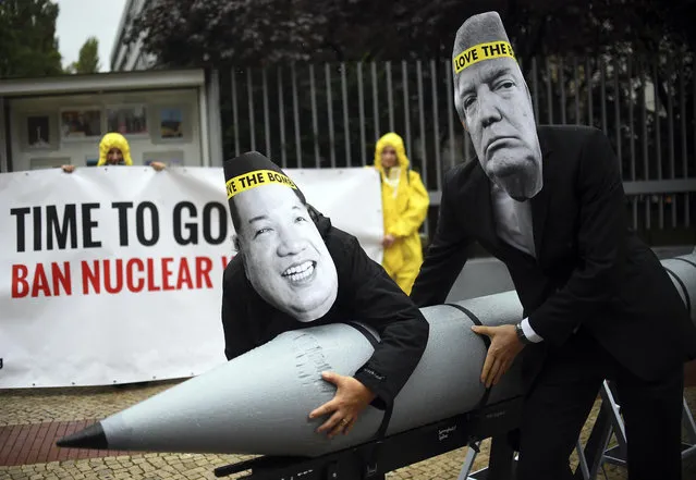 In this September 13, 2017 file photo activists of the International Campaign to Abolish Nuclear Weapons (ICAN) protest against the conflict between North Korea and the USA with masks of the North Korean ruler Kim Jong Un, left, and the US president Donald Trump, right,  in front of the US embassy in Berlin, Germany. The International Campaign to Abolish Nuclear Weapons wins the Nobel Peace Prize. The Norwegian Nobel Committee honored the Geneva-based group “for its work to draw attention to the catastrophic humanitarian consequences of any use of nuclear weapons and for its ground-breaking efforts to achieve a treaty-based prohibition of such weapons”. (Photo by Britta Pedersen/DPA via AP Photo)