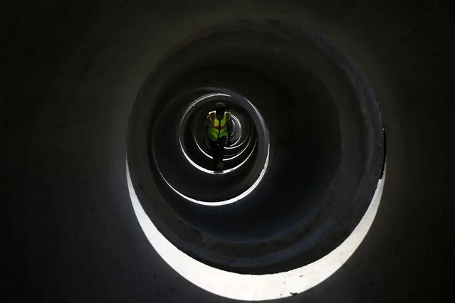 Road department workers carry out construction work to lay sewage pipes along the road on the 28th day of a government imposed lockdown amid COVID-19 spread outbreak in Kathmandu, Nepal on Monday, April 20, 2020. (Photo by Skanda Gautam/ZUMA Wire/Rex Features/Shutterstock)