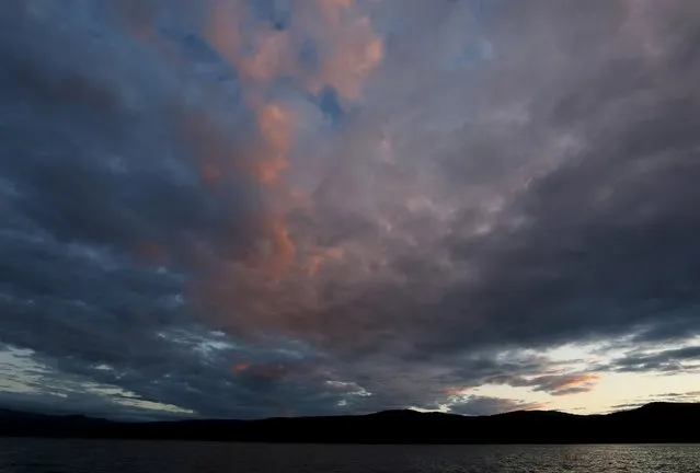 Clouds are seen in the sky after sunset above the Yenisei River in Taiga district outside the Siberian city of Krasnoyarsk, Russia, August 10, 2015. (Photo by Ilya Naymushin/Reuters)