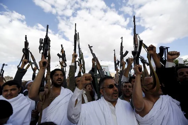Houthi followers wearing the pilgrimage dress, called ihram, hold up their weapons as they demonstrate against Saudi-led air strikes in Yemen's capital Sanaa September 11, 2015. They were also protesting against alleged restrictions on Yemeni pilgrims by Saudi authorities. (Photo by Khaled Abdullah/Reuters)