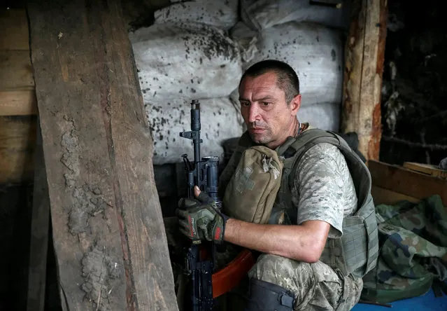 A Ukrainian serviceman is seen at his position on the front line in Krasnogorivka near Donetsk, Ukraine, August 12, 2016. (Photo by Gleb Garanich/Reuters)
