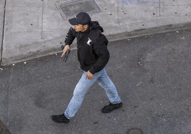 A man holds what appears to be a firearm after having driven at George Floyd protesters Sunday, June 7, 2020, in Seattle. Authorities say the man hit a barricade then exited the vehicle brandishing a pistol. At least one person was injured. The victim was a 27-year-old male who was shot and taken to a hospital in stable condition, the Seattle Fire Department said. (Photo by Dean Rutz/The Seattle Times via AP Photo)