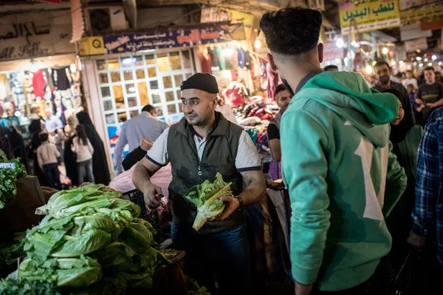 A man sells vegetables inside the Prophet Younis market in East Mosul on November 5, 2017 in Mosul, Iraq. (Photo by Chris McGrath/Getty Images)